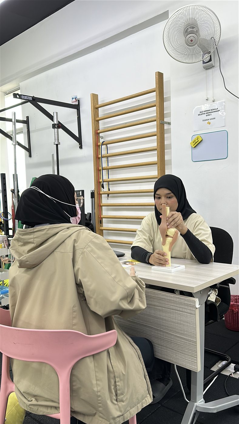 Physiotherapist showing spine anatomy during back pain consultation
